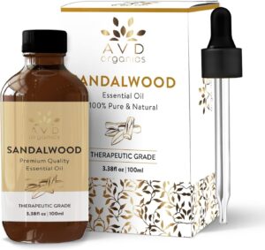 A 100ml bottle of sandalwood essential oil, next to its box and pipette. 